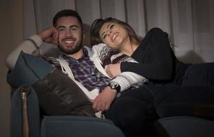 Couple having fun watching soccer game on tv photo