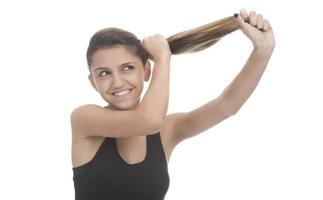 Young attractive smiling woman holding her strong hair and smiling shampoo concept isolated on white photo