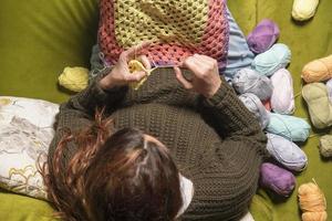 unrecognizable woman knitting photo