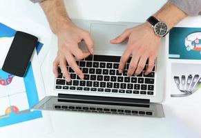 men's hands typing on the laptop on the business desk. business concept photo