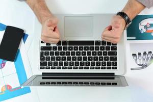 hands typing on the laptop on the business desk. business concept photo