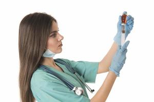 Woman Nurse with protective workwear holding Vaccine and syringe photo