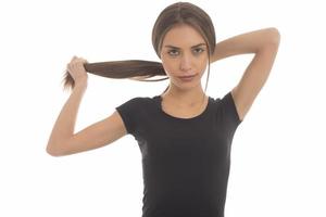 Young attractive smiling woman holding her strong hair photo