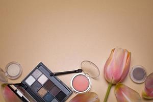 Beauty background with make-up products and tulip, with free space for text. photo