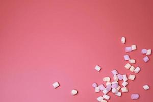 Marshmallows on the pink background, with free space for text. photo