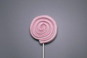 Pink lolly pop on the grey background. photo