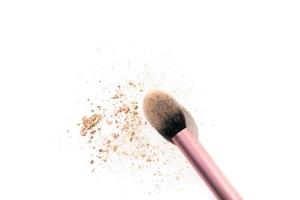 Traces of powder with a makeup brush, isolated on the white background. Copy space. photo