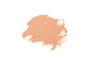 Light beige makeup smear of creamy foundation isolated on white background. Liquid foundation smudge. photo