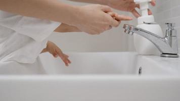 Mother practice Toddler washing his hands before breakfasts . Washing your hands for protect and reduce virus.concept for prevent germs and virus. video