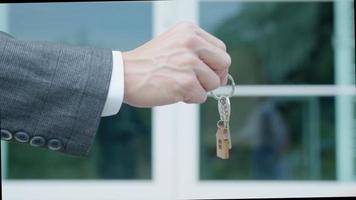 Selling home ,Landlord and New home. The house key for unlocking a new house is plugged into the door. Mortgage, rent, buy, sell, move home concept video