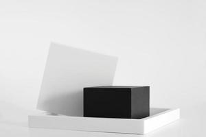 Black podium with white simple geometric forms on the white background. Podium for product, cosmetic presentation. Creative mock up. Pedestal or platform for beauty products. photo