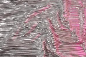 Shiny silver fabric with pink. Abstract background. Events, celebrations, Christmas, New Year. Trendy backdrop. photo