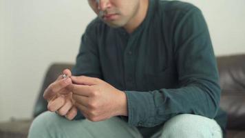 Husband holding with the wedding ring, thinking seriously sad and sad after arguing with my wife. The problems of lovers must separate. divorce concept video