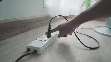 concept of save. Unplug the power plug after not being used will reduce your electricity bill. man is unplugging his appliances after not use to save electricity and reduce costs. video