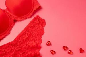 Valentine's Day background with beautiful female lacy panties, bra and hearts. Sexy underwear. Free space for text, copy space. Postcard, greeting card design. Love, celebration concept. photo