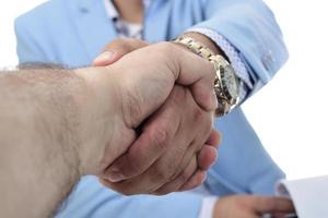 Arab businessman shaking hand for closing a deal. isolated photo