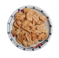 Peanuts in a cup on wooden background photo