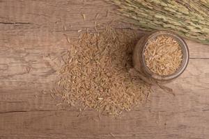 brown Jasmine rice on dark wood background with copy space, healthy food photo