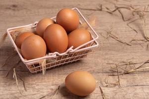 Fresh eggs in a basket on a wooden background.Copy space. photo