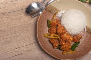 Stir-fried pork ribs with curry paste and steamed rice photo