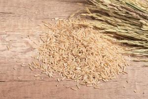 brown Jasmine rice on dark wood background with copy space, healthy food photo