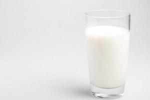 fresh milk in transparent glass on white background photo