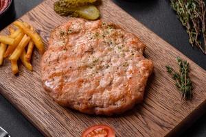 Delicious fresh grilled turkey meat steak with spices and herbs photo