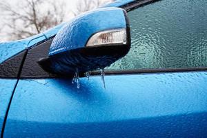 Car covered in freezing rain. Extreme winter weather for driving photo