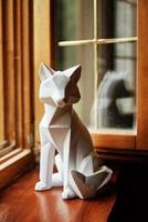 Polygonal geometric animal on windowsill near window photo