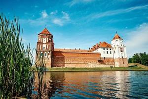 Mir castle complex in a summer day with blue cloudy sky photo