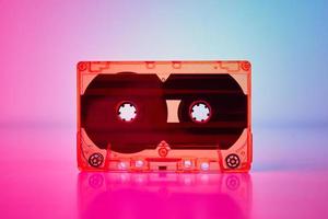 Retro cassette tape on a colorful neon background photo
