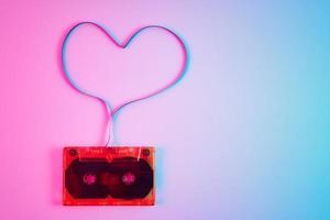 Retro cassette on colorful background with magnetic tape photo