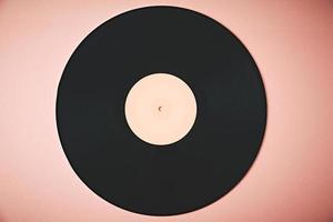 viejo disco de vinilo retro sobre fondo rosa. foto en tonos vintage