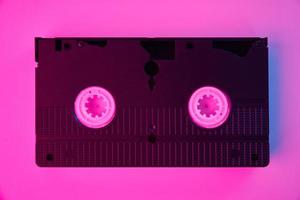 Video cassete on the color background. Retro vhs cassette tape photo
