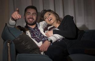 Couple having fun watching soccer game on tv photo