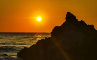 Colorful golden sunset big wave and beach Puerto Escondido Mexico. photo