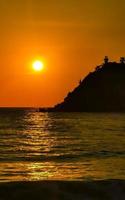 Colorful golden sunset big wave and beach Puerto Escondido Mexico. photo