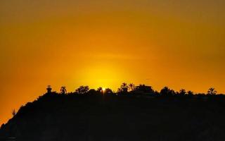 Colorful golden sunset big wave and beach Puerto Escondido Mexico. photo