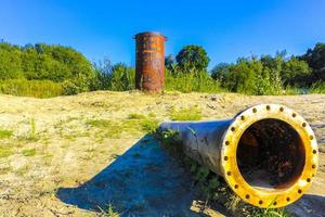 Huge drain pipe at quarry pond in Germany. photo