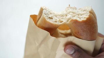 Holding half eaten fresh bagel bread video