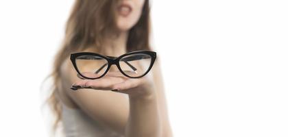 beautiful young woman holding eye glasses photo