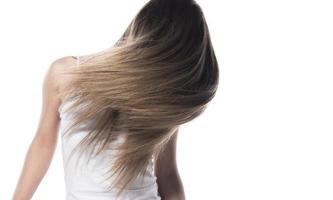 Portrait of the young woman with flying hair. isolated photo