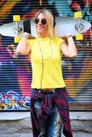 cool skateboard woman at a public graffiti park photo