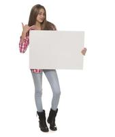 young smiling woman holding a blank sheet of paper for advertising photo