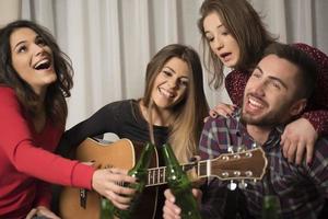 Gathering of multiracial young best friends having a fun party indoors photo