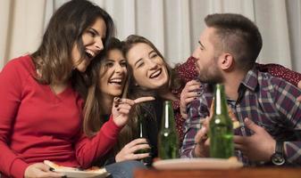 Gathering of multiracial young best friends having a fun party indoors photo