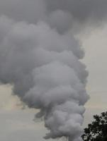 Dangerous smoke against cloudy sky. background. photo