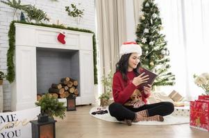 A young woman enjoying with Christmas decorations at home photo