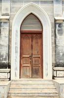 Entrance of the Gothic-style wooden and marble Christian churches is a solid and strong medieval art and is seen in many European and Christian churches around the world. photo