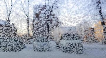 Frost patterns on the windshield of the car. The concept of changing weather photo